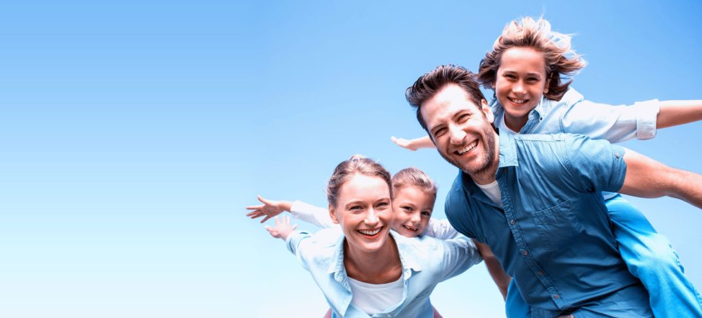 A family standing together outside.