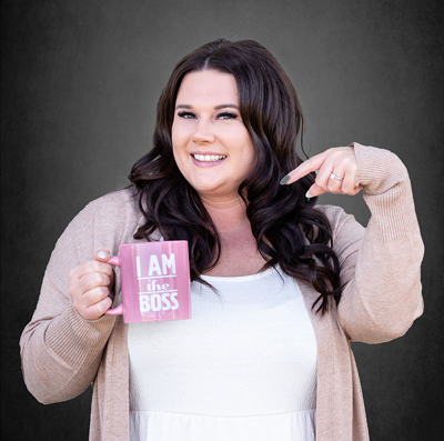 Office Administrator, Alysha pointing at her pink mug which reads 'I am the boss'.