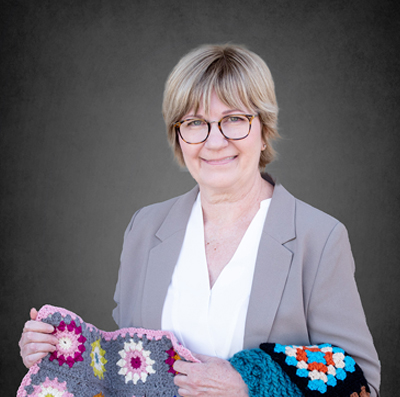 Dental Hygienist, Sue holding a kitted blanket.