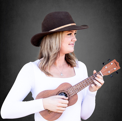 Dental Assistant, Tiffany wearing a cowboy hat and playing a ukelele.