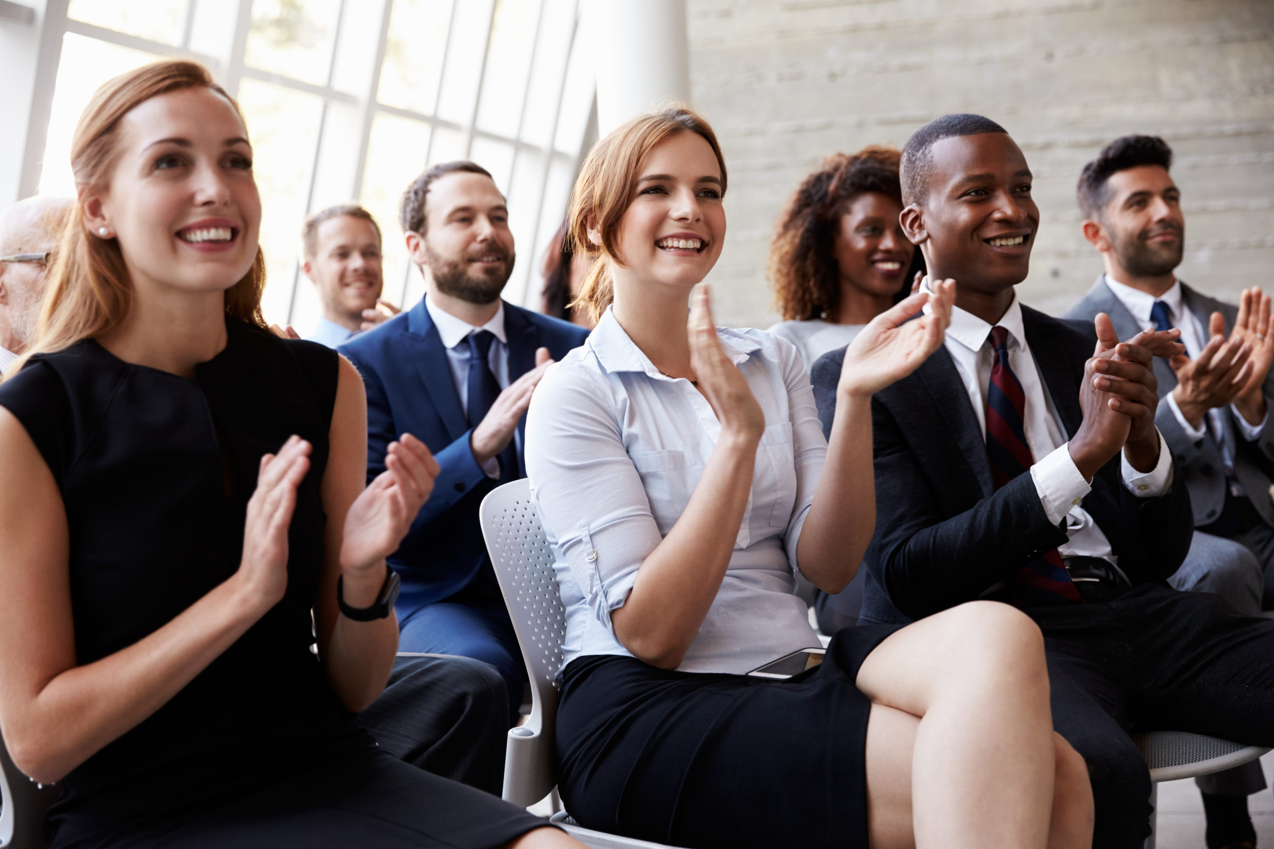 Smiling staff at a meeting.