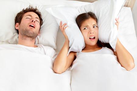 man snoring in bed advertising snoring appliance