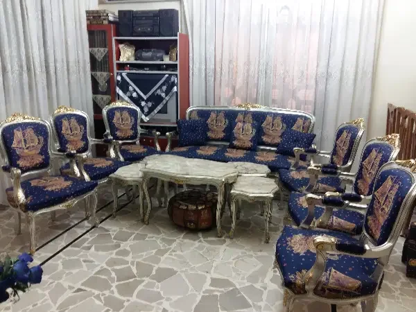 غرفة ضيوف لون كحلي مع طاولات