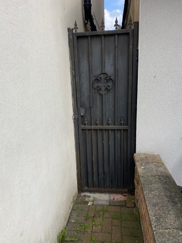 Rear access route where equipment could not be brought in due to the locked side gate.