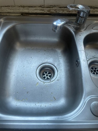 Kitchen waste pipe investigation during internal drainage works at a property in Bethnal Green, London.