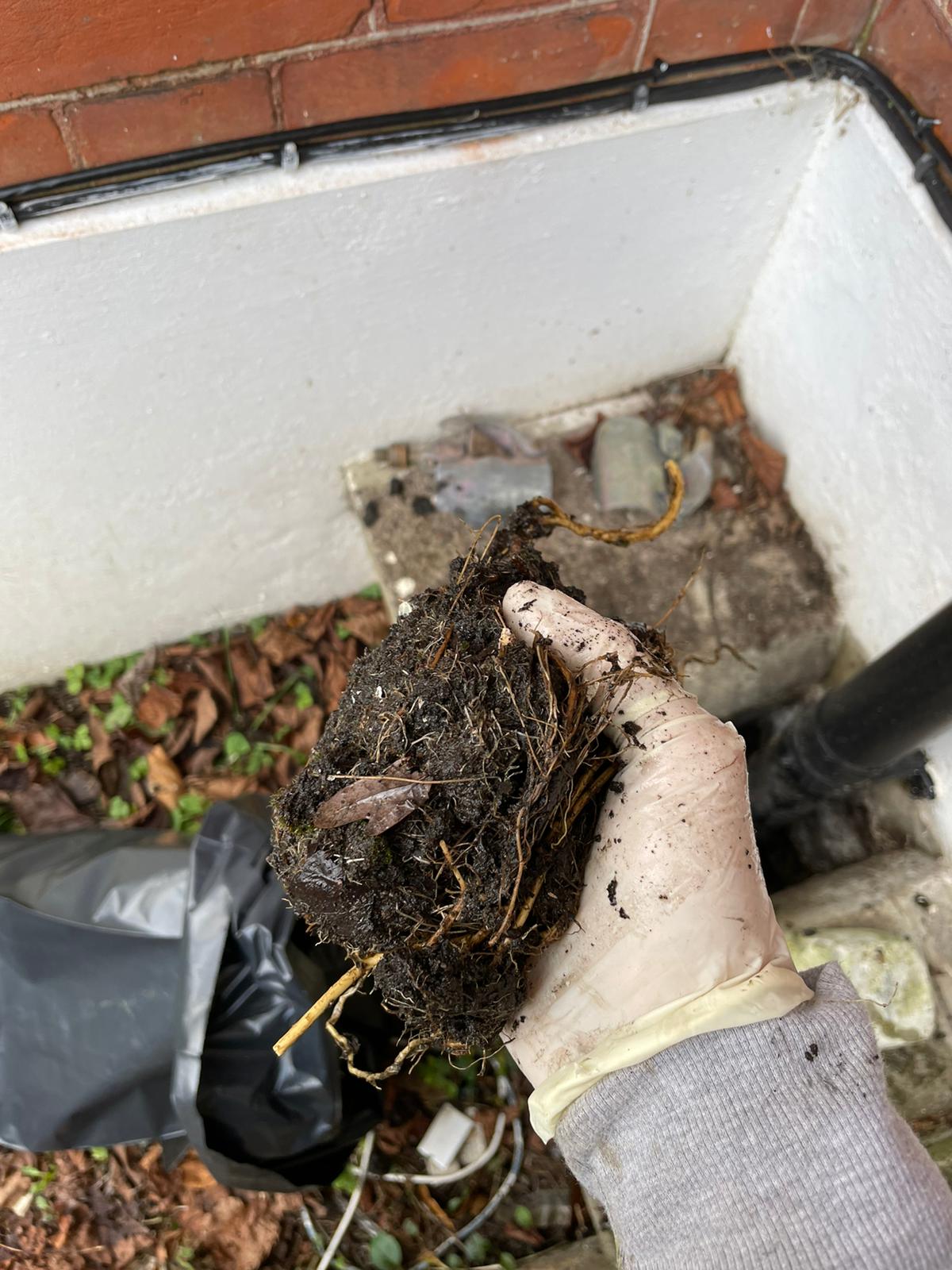 Blocked gully causing water buildup beside the property in N13.