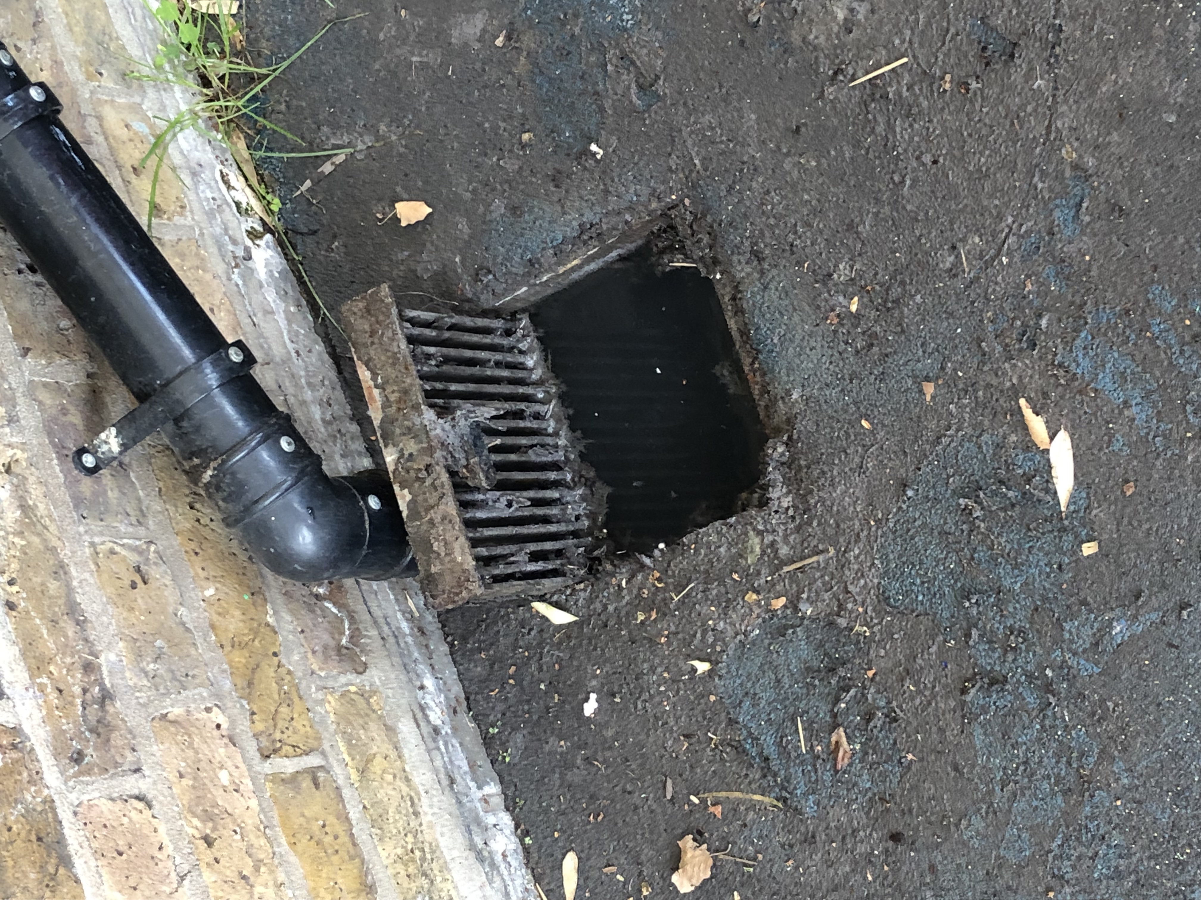 Surface gully obstructed by silt and debris causing pooling in SW6 Fulham.