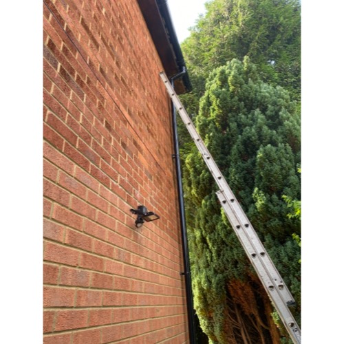Blocked rainwater downpipe cleared to restore proper roof drainage in Hazlemere