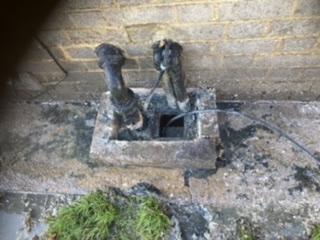 Blocked gully with food waste prior to clearance