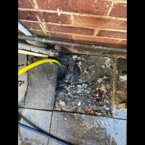 Overflowing gully inspected in Reading prior to clearance works.