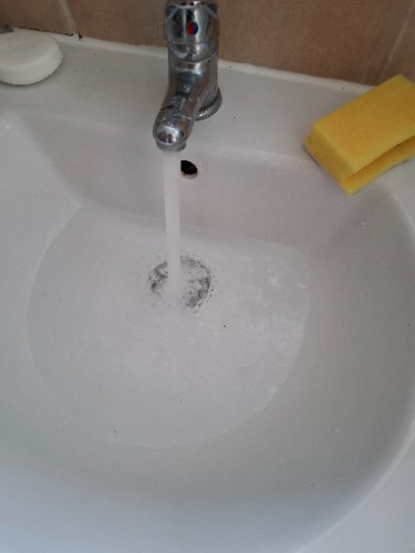 Blocked bathroom sink waste identified during investigation at a property in Bedford.