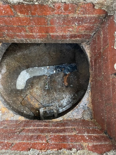 Blocked gully identified during an inspection at a property in Canning Town.