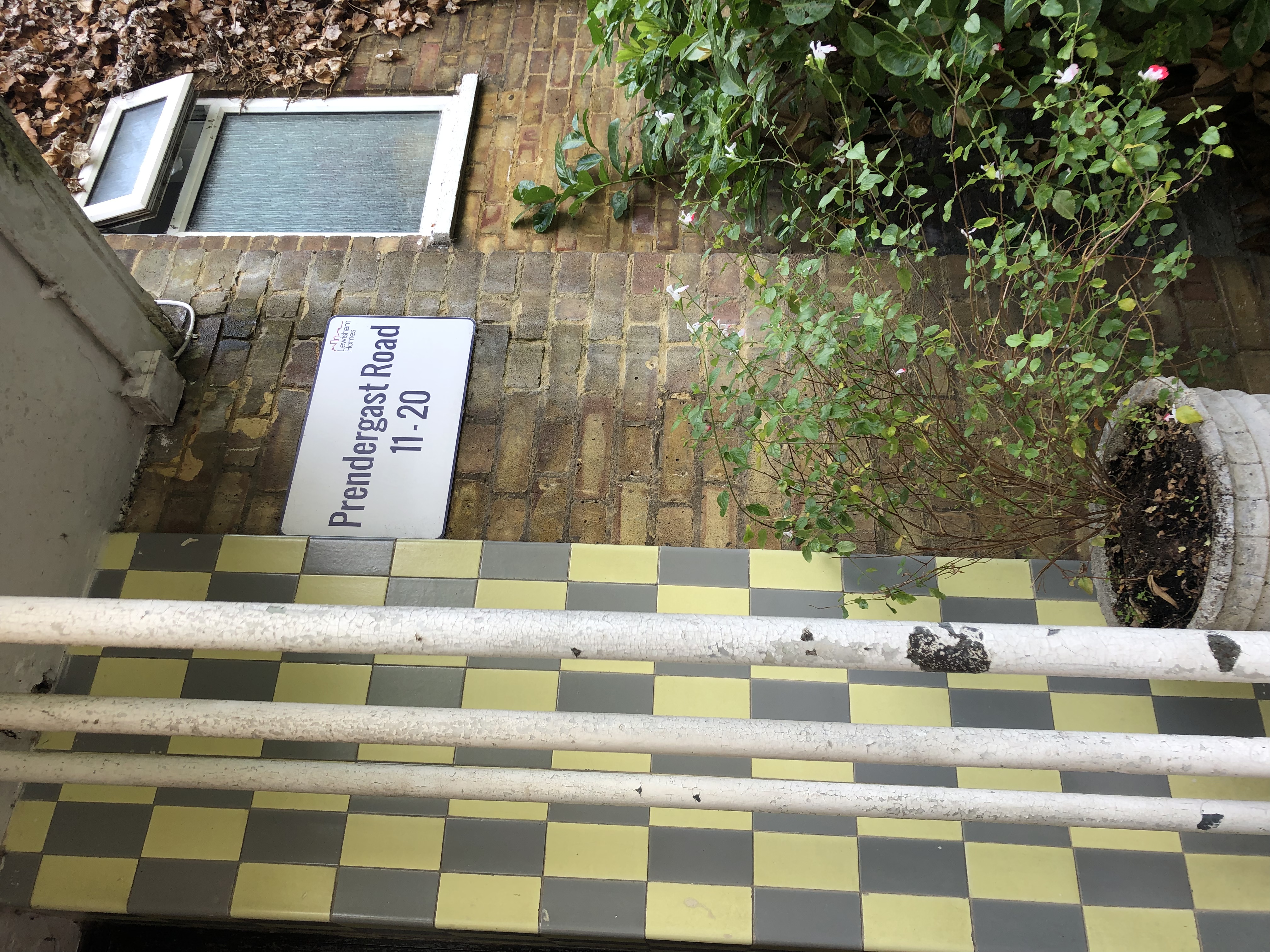 Blocked communal downpipe identified during an inspection at a residential building in Blackheath.