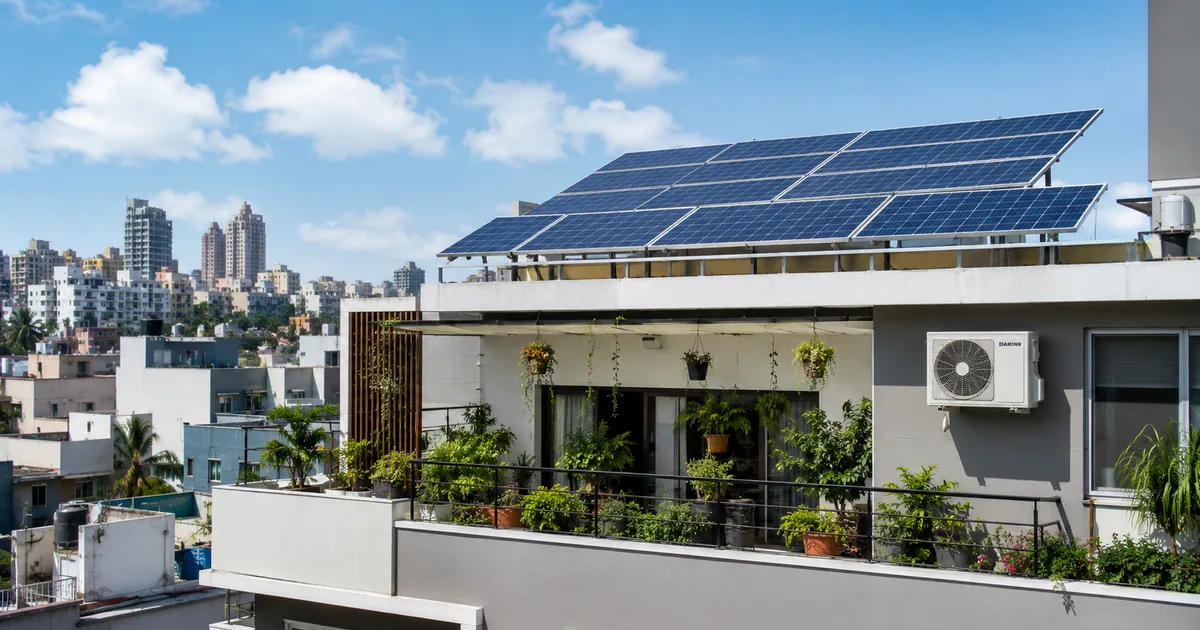 Rooftop solar panels on Indian house with inverter AC - sustainable cooling solution
