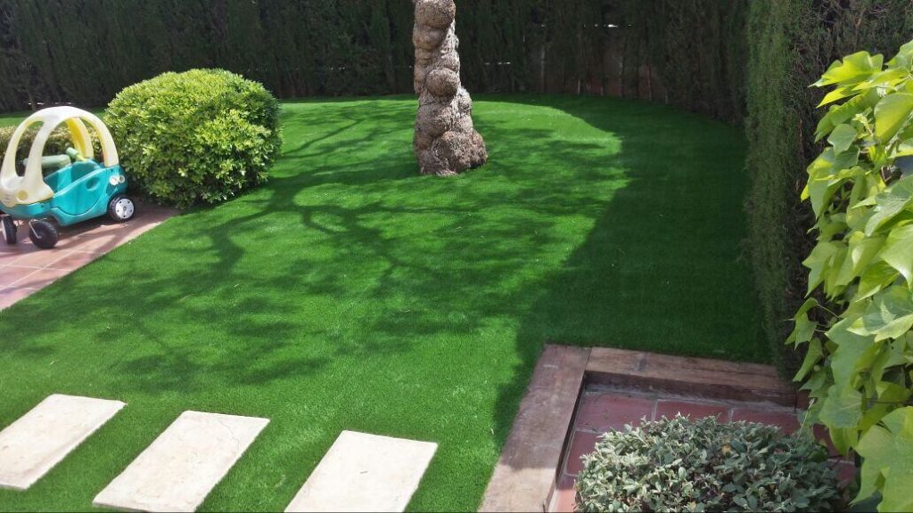Instalación de césped artificial en jardín residencial