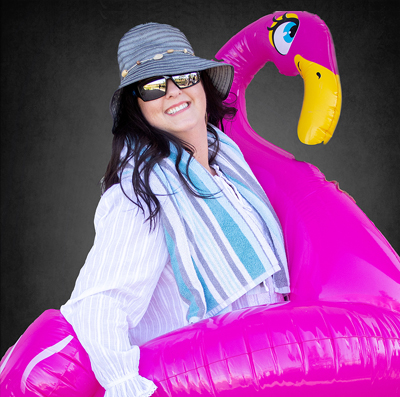 Dental Assistant, Jaimie wearing a bucket hat, wearing glasses and an inflated flamingo.