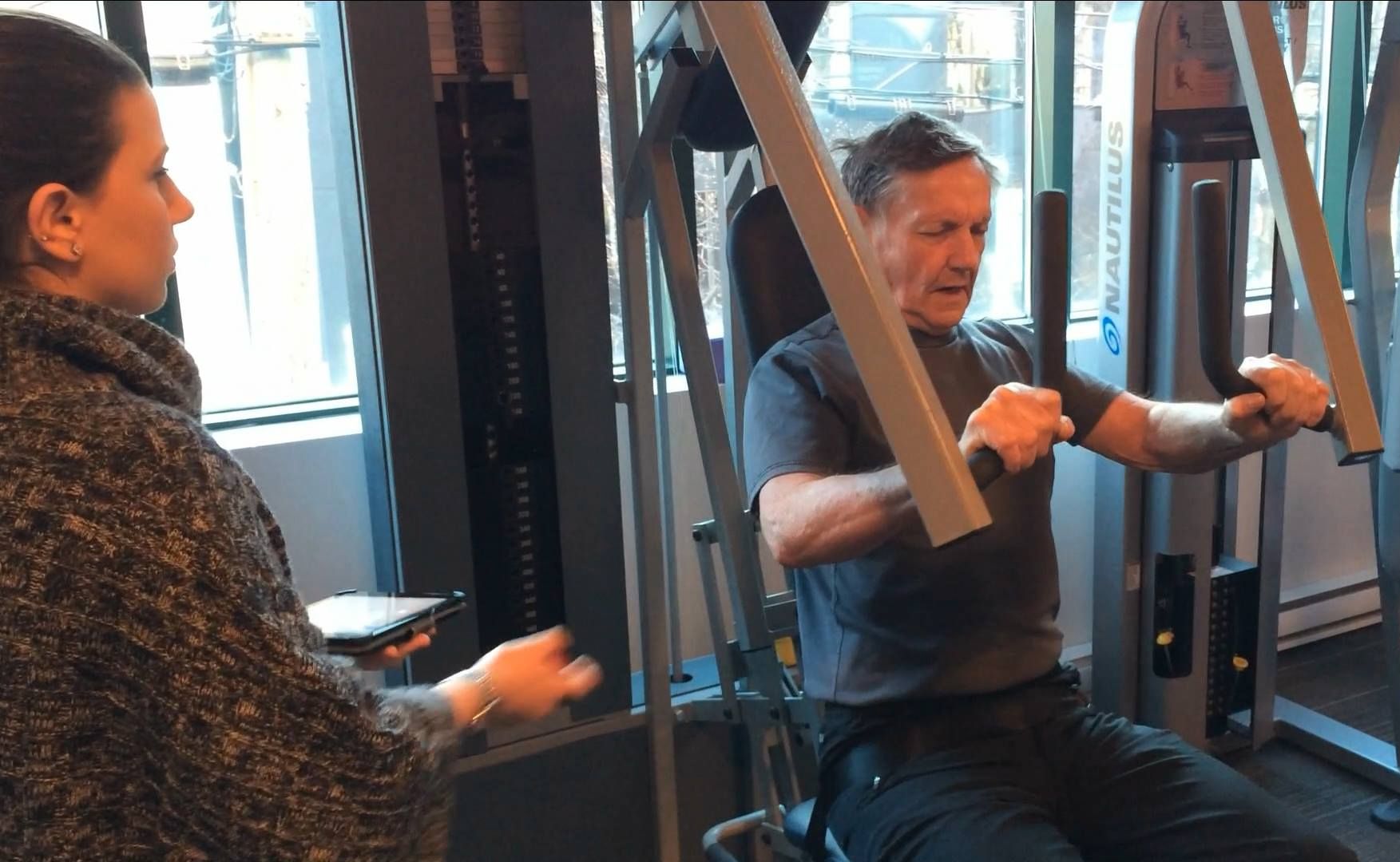 A man doing strength training on a weight machine.