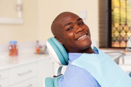A man smiling at the Dentist.