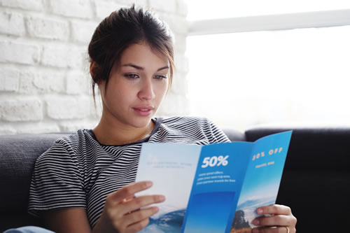A woman reading a pamphlet