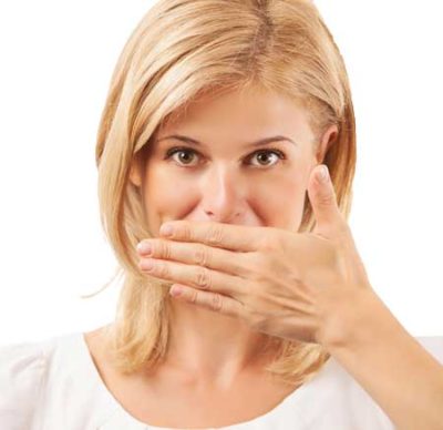 A woman covering her mouth.