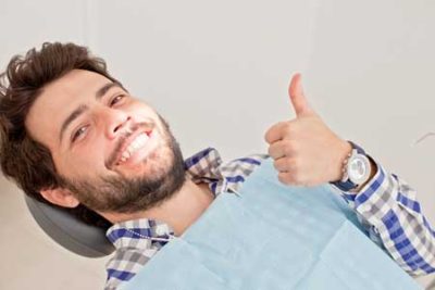 male patient give thumbs up after sedation for dentistry