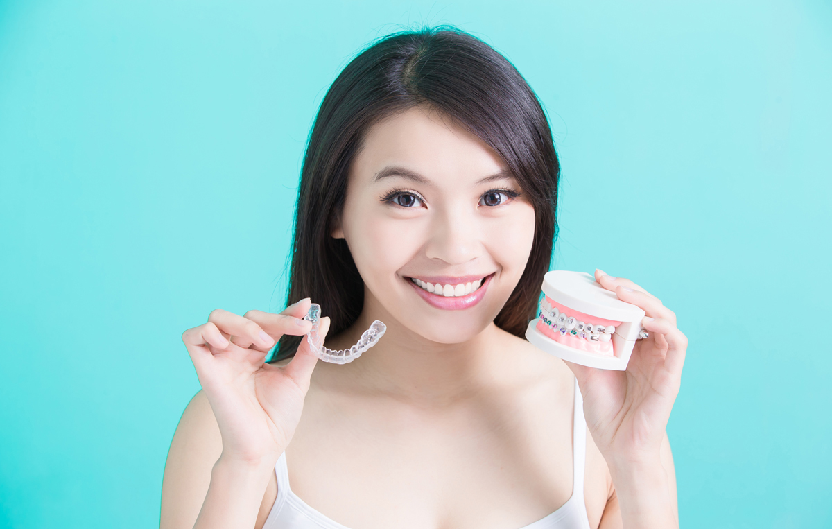 woman holing invisalign