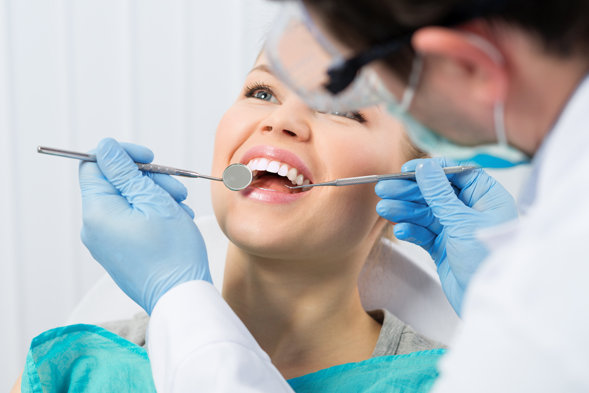 woman being examined by the dentist