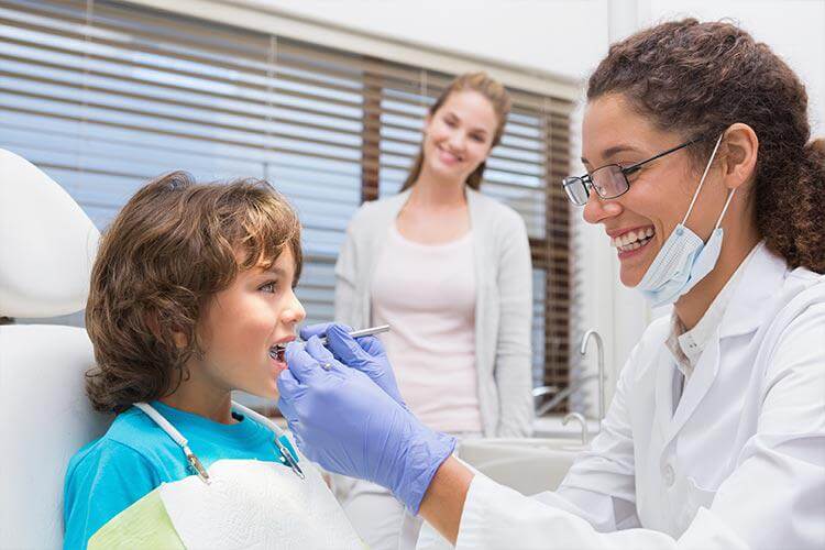 child smiling during a dental exam