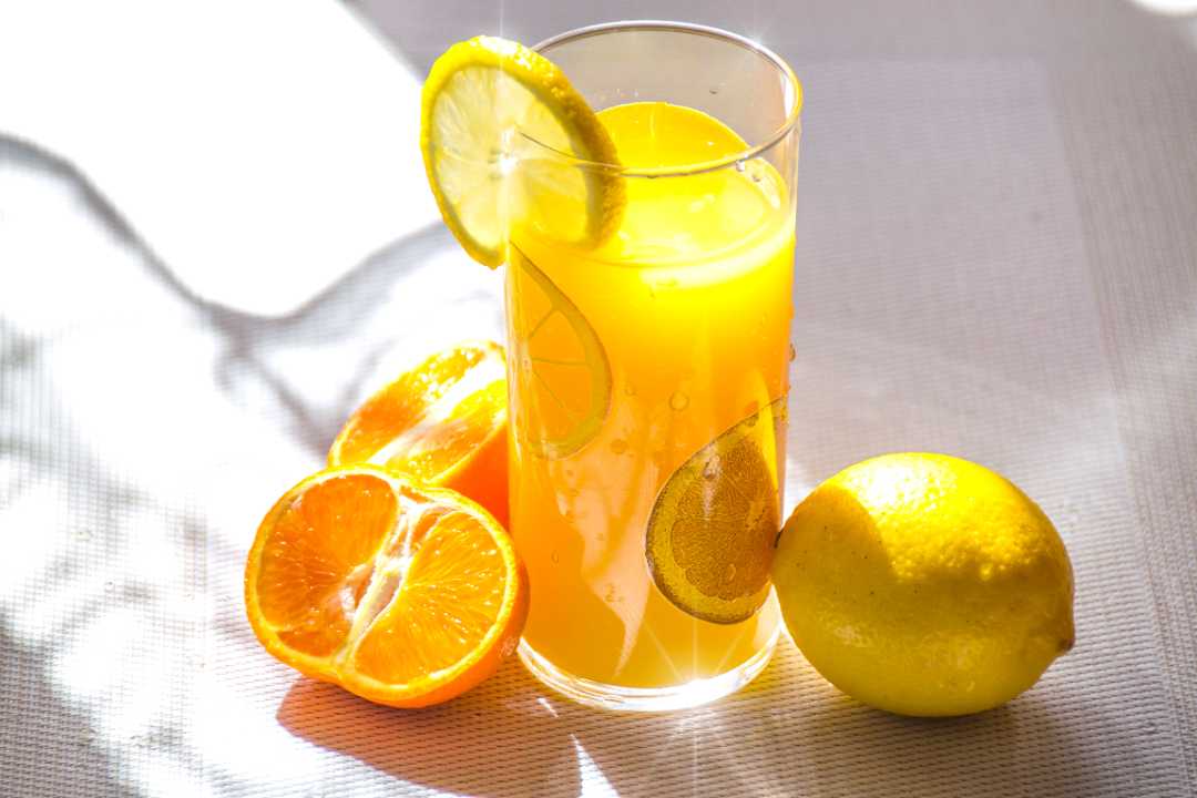 orange juice with a lemon garnish