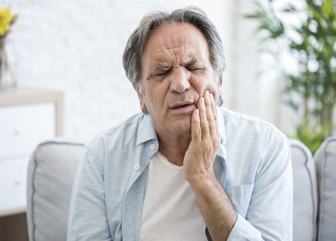 senior man suffering from a toothache