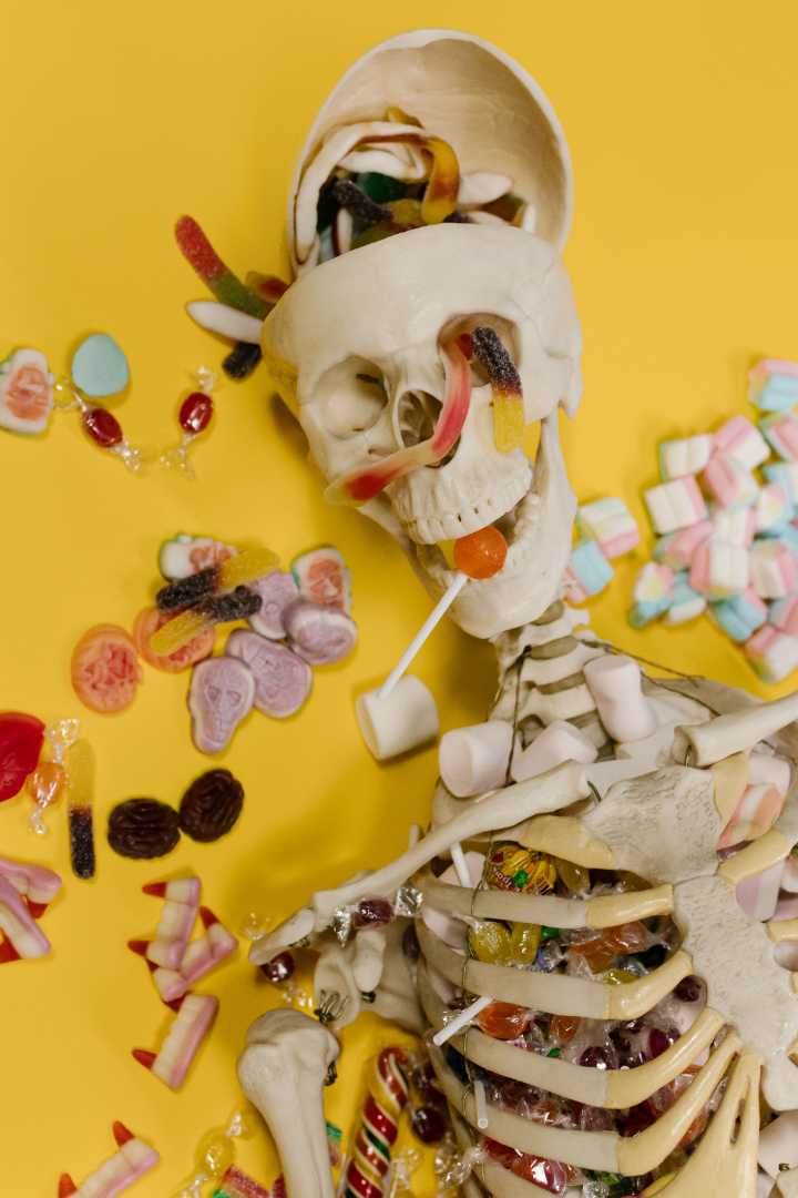a skeleton decoration surrounded by candy