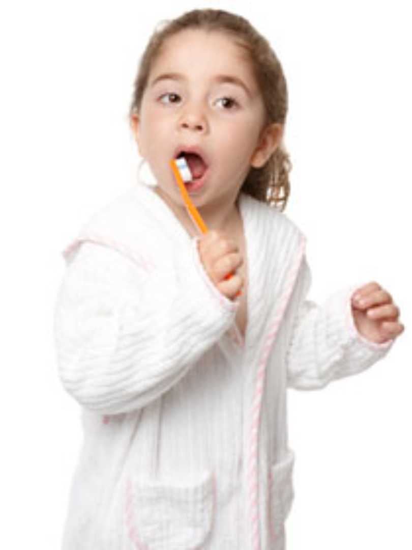 young child brushing their teeth
