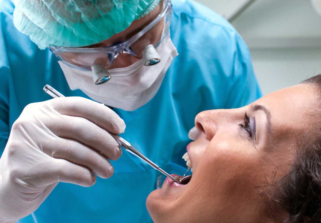 A woman at the dentist before a tooth extraction