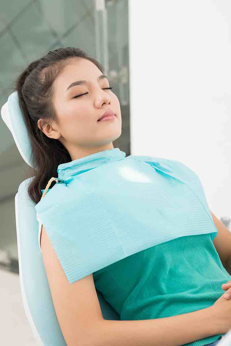 A woman under sedation at the dentist.