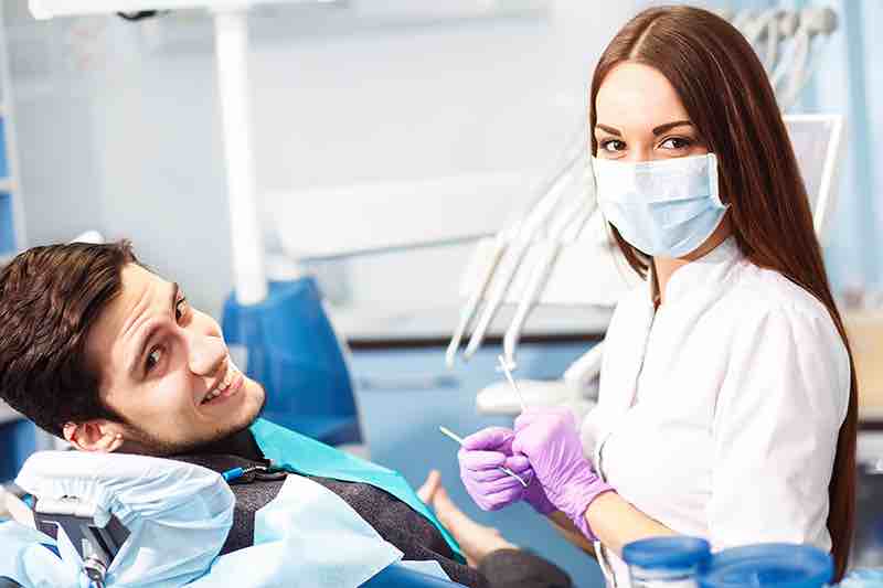 A dentist with her patient before root canal therapy.