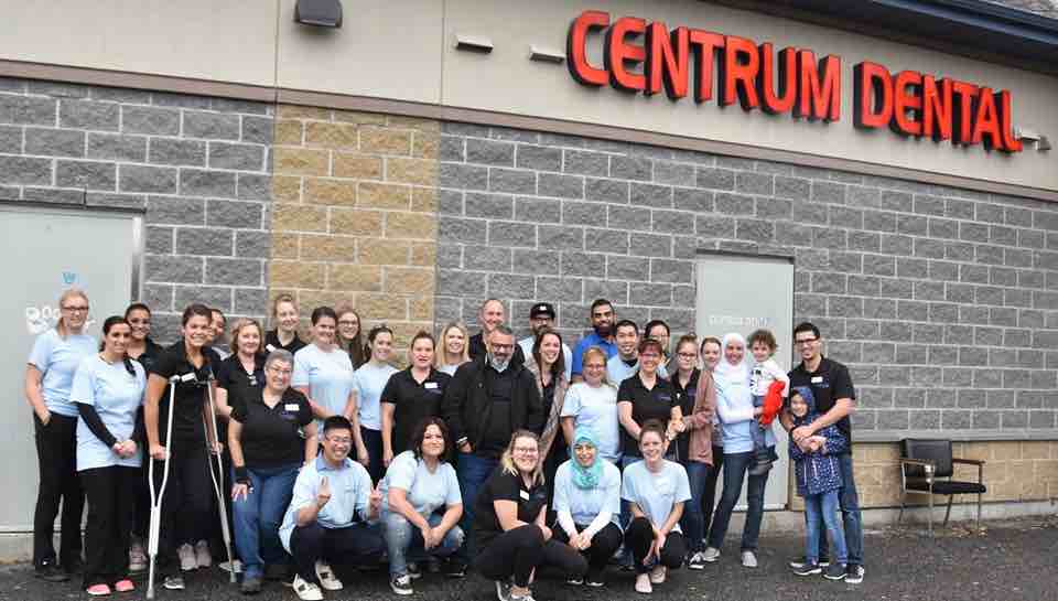 The Centrum Dental Team poses for a photo in the parking lot with 2 child patients on Free Dentistry Day 2019