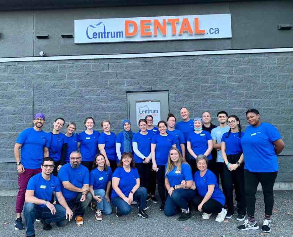 The Centrum Dental Team poses for a photo in the parking lot on Free Dentistry Day 2023