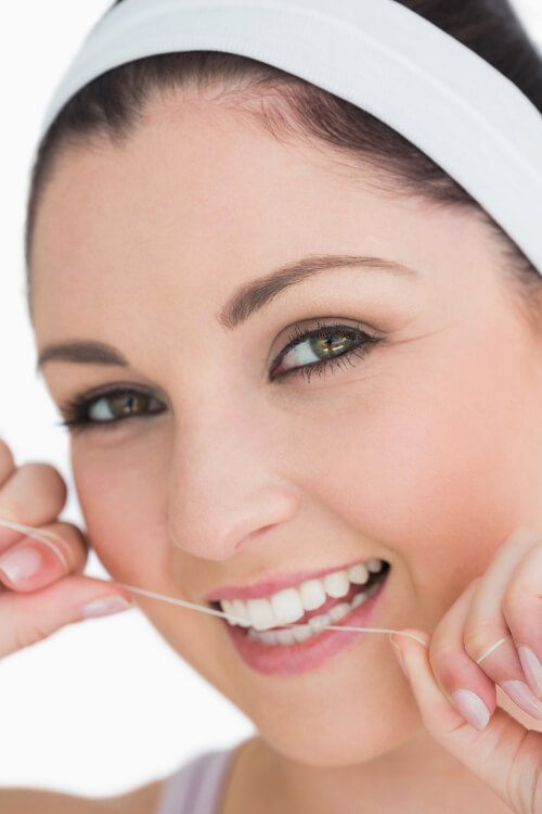 Woman flossing her teeth