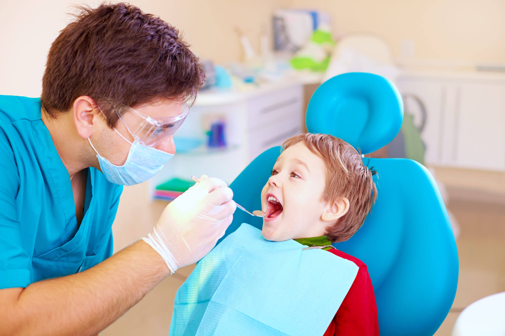 Dentist checking kids teeth