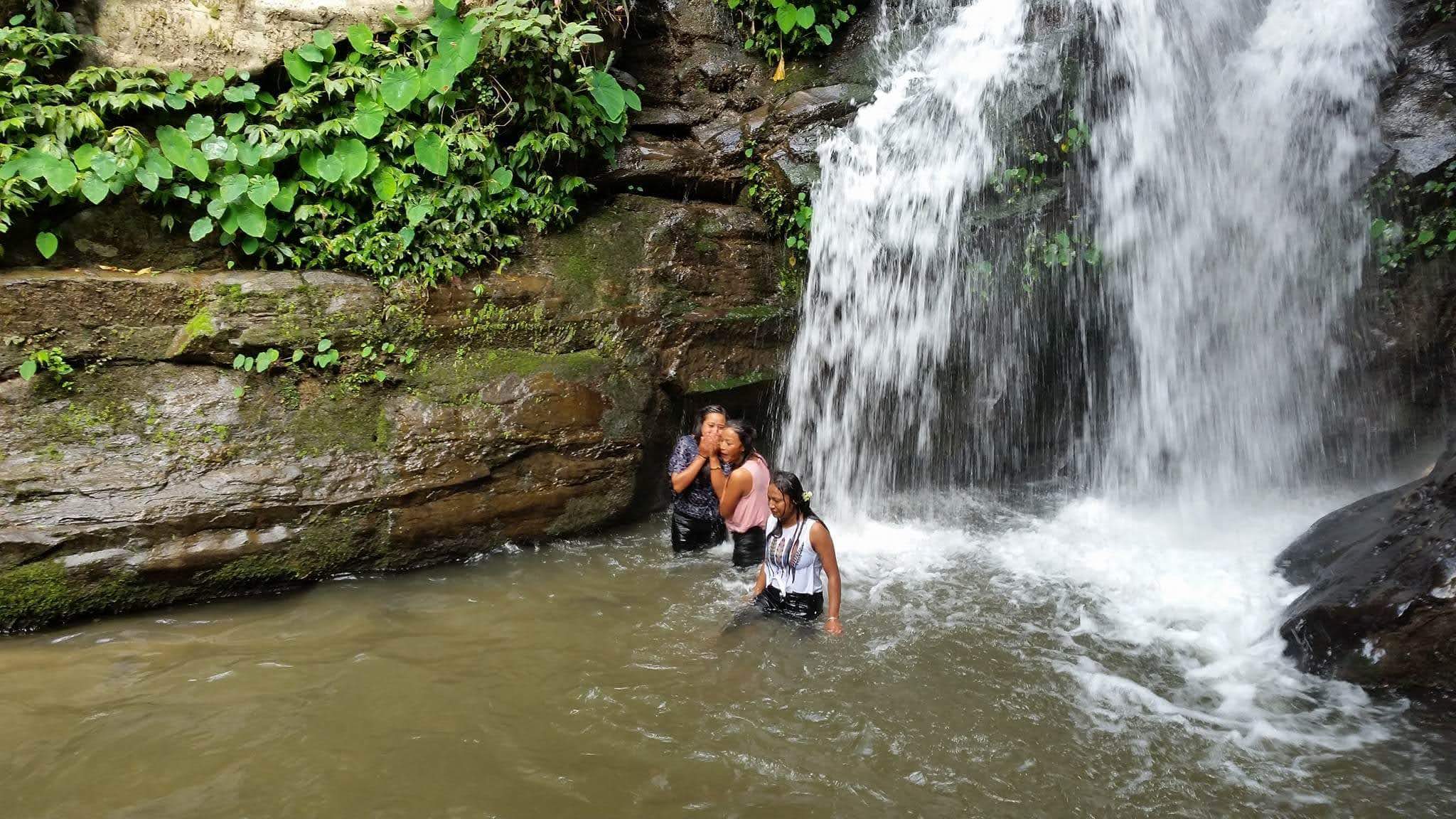 Visitors enjoying a natural spring at Bastola village