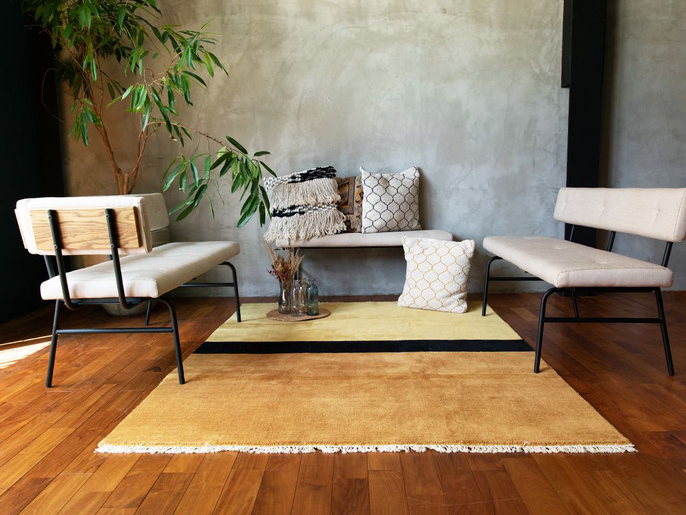 木製フローリングの室内に配置された灰色のサムノルドベンチソファ