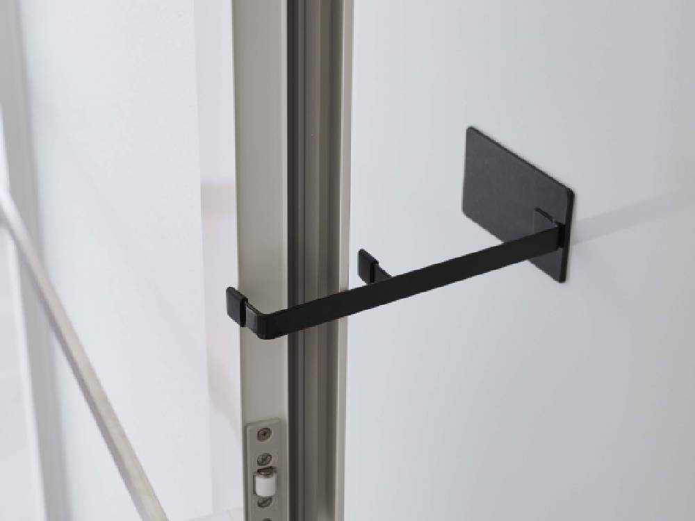 タワーのマグネット浴室扉ストッパーが取り付けられた金属製の浴室ドア