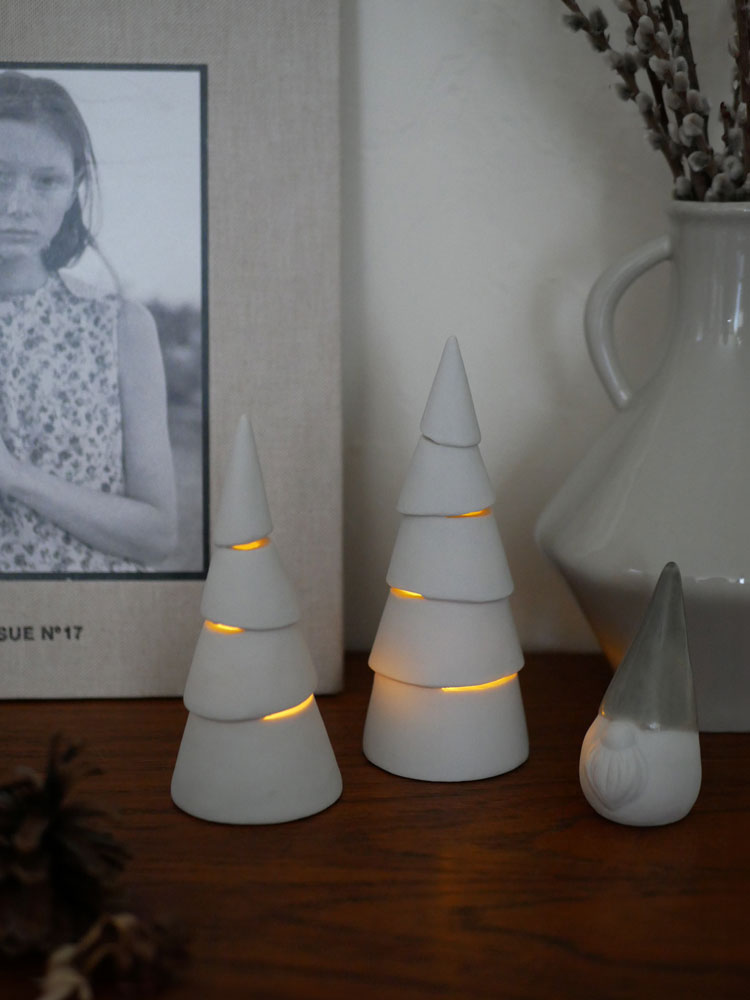 灯りが漏れる九谷焼製のComore Sunクリスマスツリー。エバーグリーンにクリスマスオーナメントが飾られた手作りデコレーション