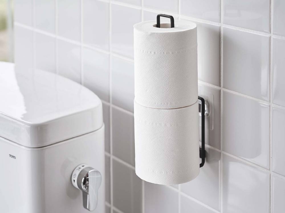 スチール製のタワータイプトイレットペーパーホルダーが浴室の壁に取り付けられている様子