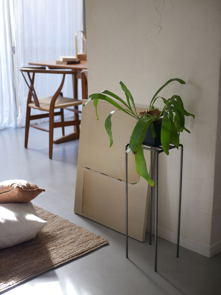ウエストビレッジトーキョーのアイアンディスプレイプラントスタンドKNOPに飾られた観葉植物が木製の床の上に置かれている