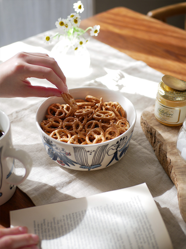 アラビア【プータルフリ ボウル】、直径約150mm、高さ67mmの磁器製ボウルにプレッツェルやフィンガーフードが盛られています。