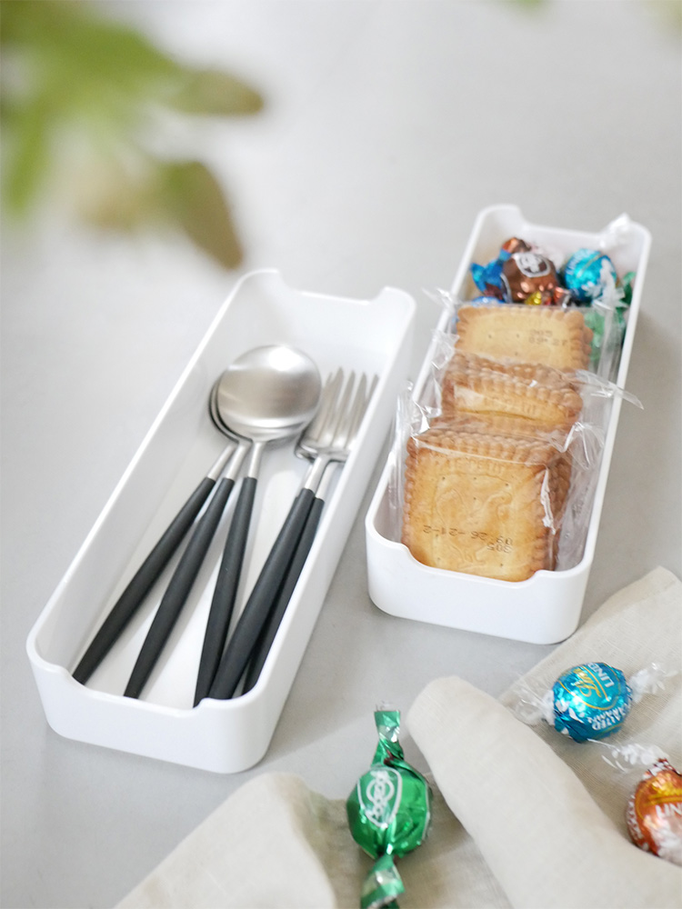 カウンタードロワー上にテーブルウェアや果物、デザートが並べられたキッチンの画像