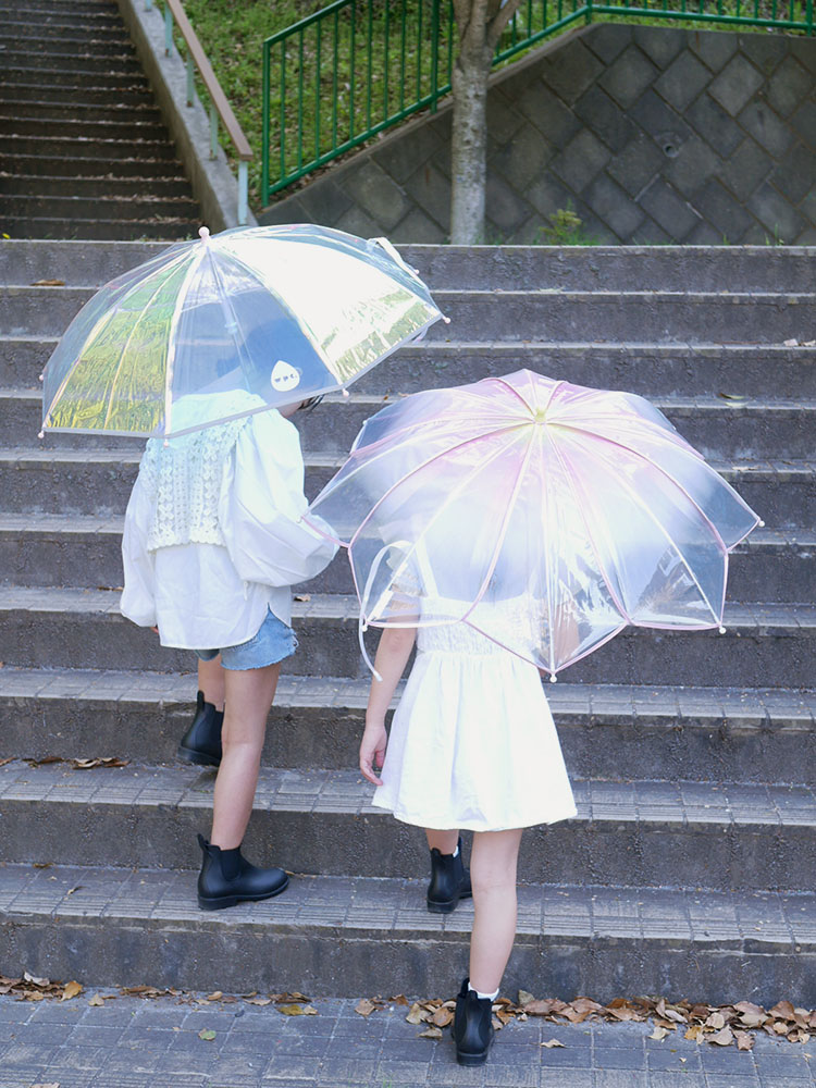 シャイニーアンブレラを持って歩くキッズのファッションイメージ