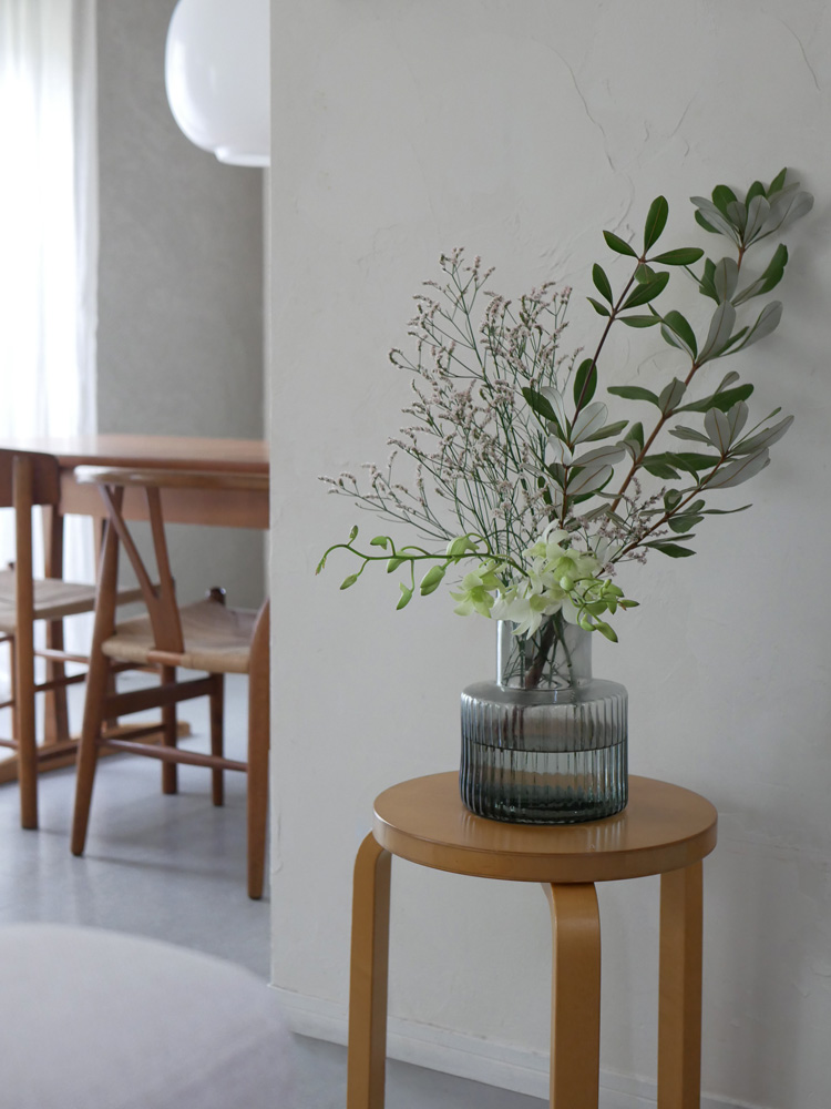 シセイのGLASSフラワーベースに紫陽花の花束が木の床の上に配置されている様子