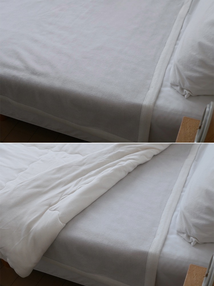 シングルサイズのココマニオーガニックコットン毛布が整然と敷かれた白いベッド